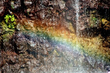 Rainbow reflection in the mist by the Devorah Waterfallsの写真素材