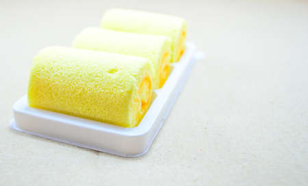 Orange flavored cake roll on trayの写真素材