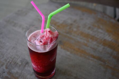 Roselle juice smoothie on wooden table backgroundの写真素材
