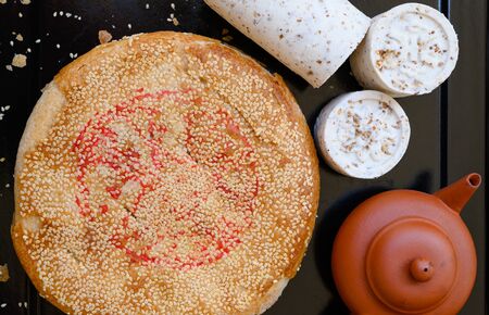 Chinese pancake made from rice-flour , The roll type filled with beans ,the round type filled with taro and sesame  ( ka-nom goh )の写真素材