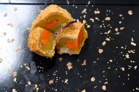 Mid-autumn festival Moon cake stuffed with nuts, durian paste and egg yolkの写真素材