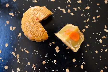 Mid-autumn festival Moon cake stuffed with nuts, durian paste and egg yolkの写真素材