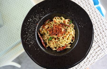 Stir-Fried Spaghetti With Clams, Dried Chili And Crispy Baco. top viewの写真素材