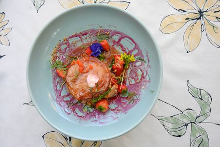 grilled pork ham topped with spicy mixed fruit salad and Strawberry Sauceの写真素材