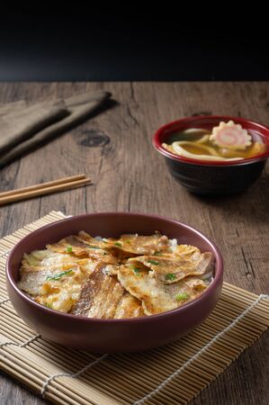 Butadon, Japanese rice bowl dish consisting of bowl of rice topped with pork belly simmered surved with with Japanese oden soup.の写真素材
