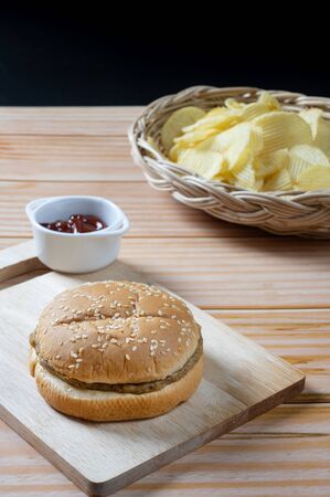 Delicious low fat hamburger and potato chips in basket with ketchup.  Ready to Eat.の写真素材