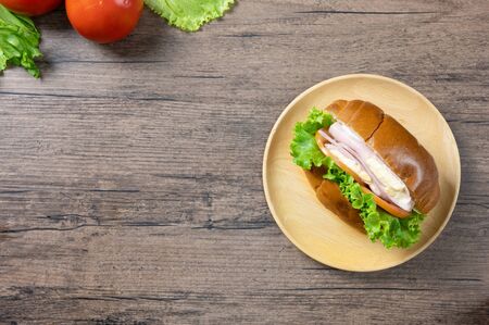 Delicious sandwich with fresh salad, Ham and cheese on wooden background. Top view with copy space. Flat lay.の写真素材