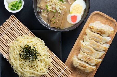 Zaru Ramen ( Japanese cold buckwheat noodles served on bamboo colander) and dipping cold soup, Gyozas, (fried japanese dumplings), tonkotsu ramen (Japanese noodle in pork Bone based soup). top view.の写真素材