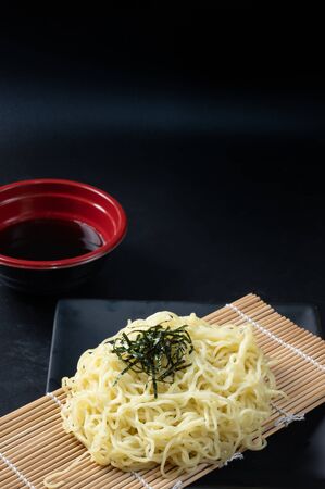 Zaru Ramen, Japanese cold buckwheat noodles served on bamboo colander with seaweed,chopped green onions, grated wasabi,Grated radish and dipping cold soup.の写真素材