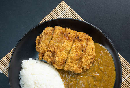 Tonkatsu Curry Rice (Japanese deep-fried pork cutlet with Curry rice). top view on black background. flat lay.の写真素材