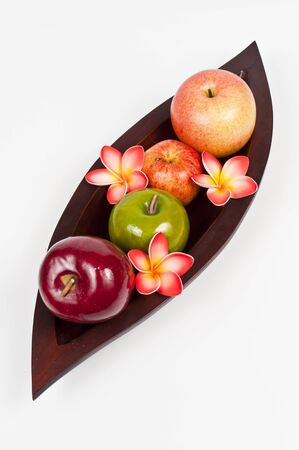 Apples in the wooden leaf trayの写真素材
