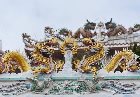 Golden dragon decorated on Chinese temple roofの写真素材