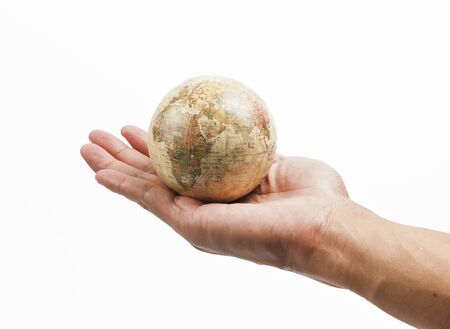 Vintage world map in hand isolated on white backgroundの写真素材