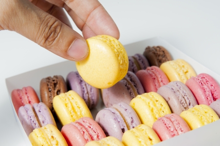 pick up one yellow sweet cake from the boxの写真素材