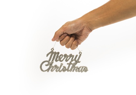 One hand holding silver Merry Christmas signの写真素材