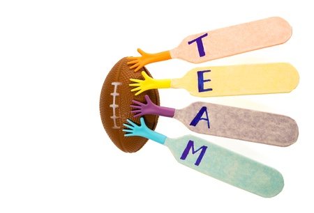 Team hand with American footbal isolated on white backgroundの写真素材