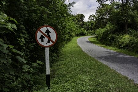 No overtaking sign along curve roadの写真素材
