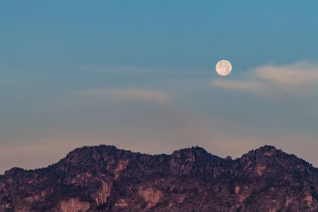 Moon in the morning over the mountainの写真素材