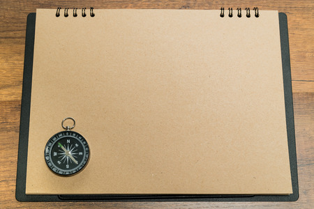 Blank brown paper with black compass on topの写真素材