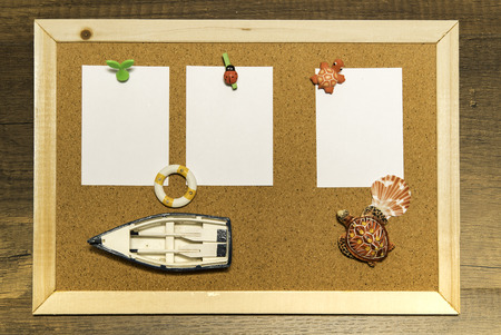 Cork board with blank white paper decorate with small boat and turtles