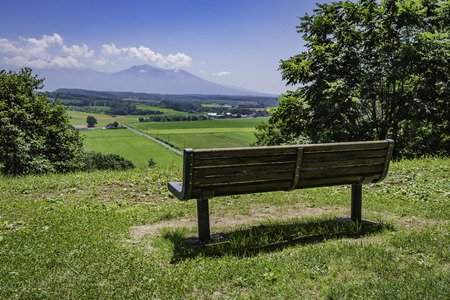 Empty long bench in sunny day with beautiful viewの写真素材
