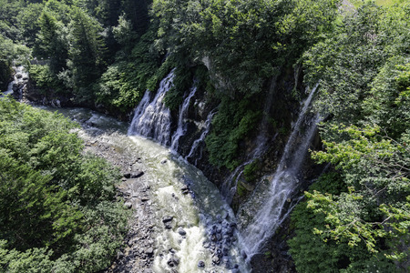 Beautiful waterfall flow from the cliff to riverの写真素材