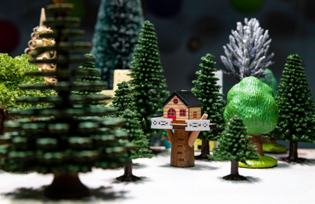 House on tree around with green Christmas treeの写真素材