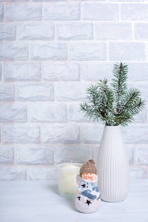Christmas Tree Pine Branches and Christmas balls on a light gray table with light bricked background.の写真素材