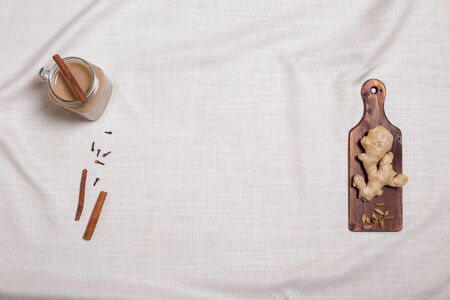 Masala tea with spices and ingredients on light linen. Horizontal with copy space