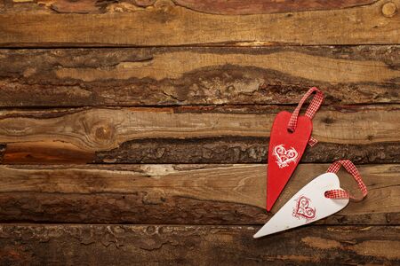 Valentines day love heart shaped close up decoration on rustic style wooden background with copy...
