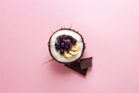 Tasty appetizing smoothie made from blackberries, bananas, cacao and yogurt. Served in coconut bowl...