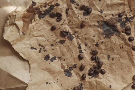 Brown abstract background with blots and coffee beans. Craft papper texture with coffee drops.の写真素材