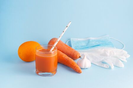 Healthy super food for flu remedy with carrot, garlic and orange. Coronavirus preventation on light...