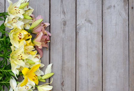 Fresh bouquet of white lilies on wooden backgroundの写真素材
