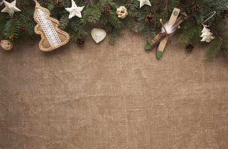 Zero waste Christmas flat lay with pine branches and eco toys on sackcloth.の写真素材