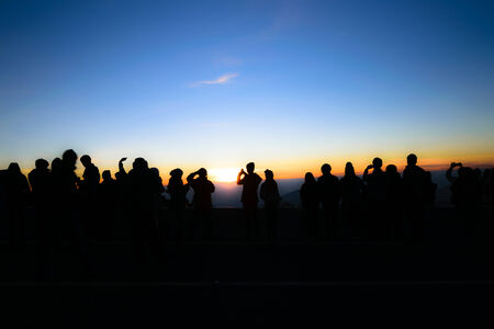 Silhouette of people and tourist during a beautiful mountain sunrise at kiew mae pan, Doi Intanon, Chiangmai, Thailandの写真素材