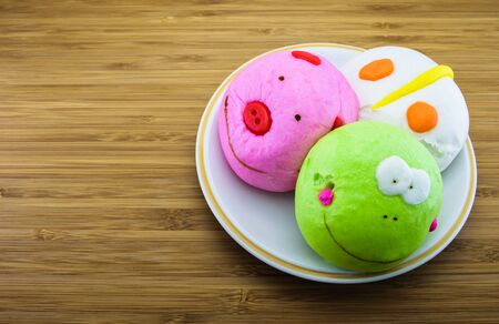 Fancy chinese steamed buns on wood backgroundの写真素材