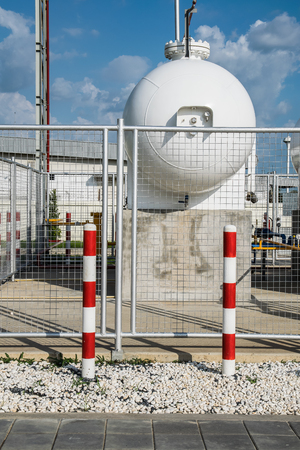 LPG cylinder tank isolated in safety zone inside a fence, Safety precaution conceptの写真素材