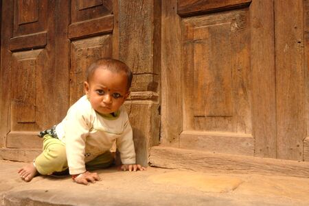 Baby crawling on floor at Jungu Narayan village,Kathmandu old city in Nepal のeditorial素材
