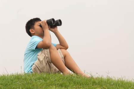 Young Boy looking into binocular の写真素材