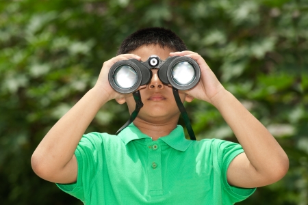 Young Boy looking into binocular の写真素材