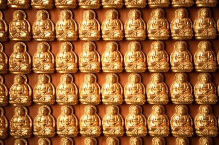Little golden buddha on the wall background  のeditorial素材