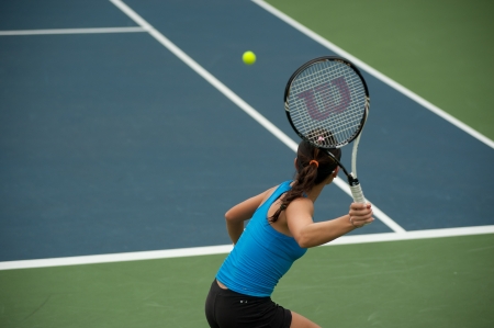 BANGKOK,THAILAND- NOV 29    Wing-Yau Venise Chan Hong Kong player tennis returns a serve in her at semi final match,during Chang ITF Pro Circuit 2012 on November 29,2012 at Rama Garden Hotel in Bangkok,Thailand のeditorial素材