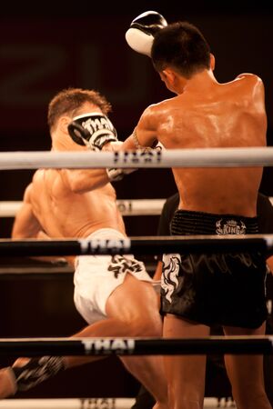 BANGKOK, THAILAND-NOV 27  Unidentified fighters fight Muaythai at Thai Fight Muay Thai    The World s Unrivaled Fight at Imperial Departmaent Store stadium on November 27, 2011 in Bangkok,Thailand  のeditorial素材