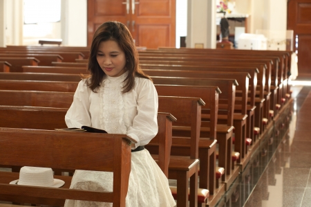 Pretty Thai woman stydy bible in Christian church  の写真素材