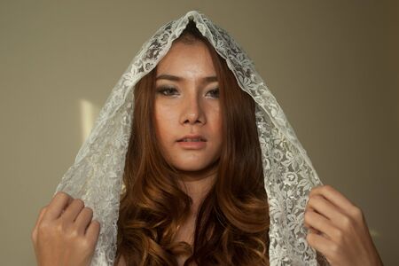 Pretty Asian woman with white scarf  の写真素材