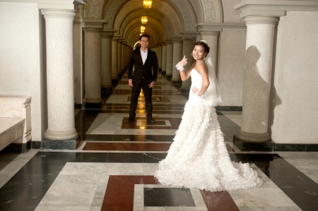 A beautiful Asian bride and handsome groom at Christian church during wedding の写真素材