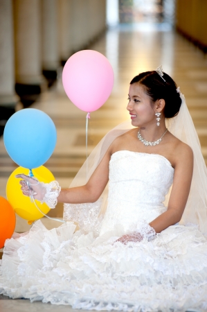 Beautiful Asian bride posing in Christian church  の写真素材