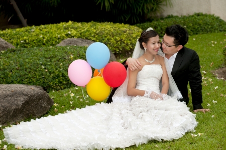 Happy Asian bride and groom on their wedding day  の写真素材