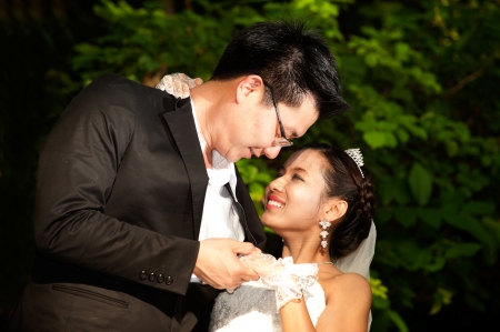 Happy Asian bride and groom on their wedding day  の写真素材